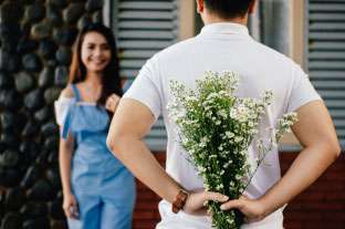 Dating Couple: Man Giving Woman Flowers