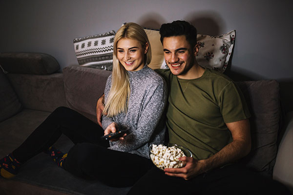 First Date Ideas - Netflix and Cuddling Couple