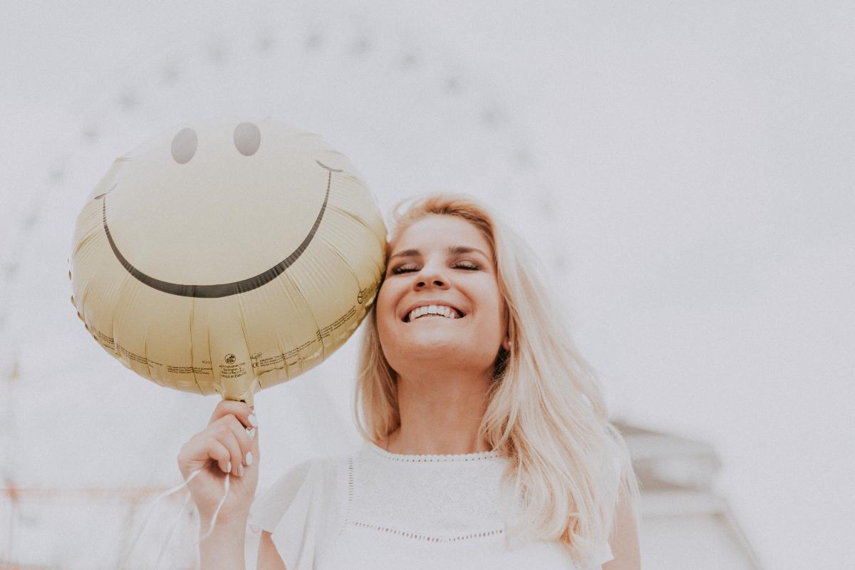 Woman With Smiley Face Balloon