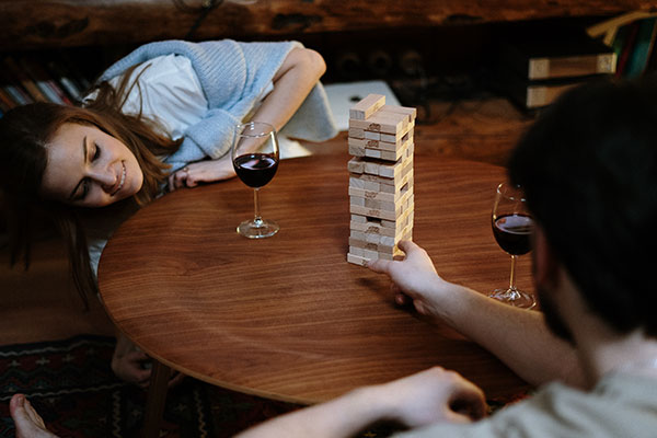 Couple Drinking Wine - Playing Jenga Game